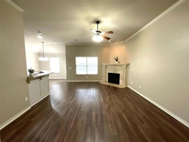 Unfurnished living room featuring dark hardwood / 