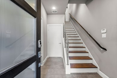 First floor entrance with access to the garage as well as the bedroom with it's own bathroom, mini-kitchen, and stacked washer and dryer!