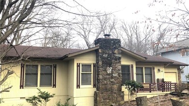 Flat driveway and stone fireplace.