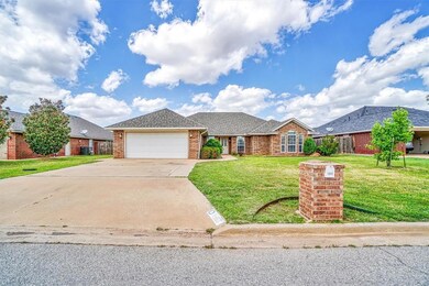 Ranch-style house featuring a garage and a front l