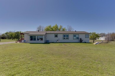 Single story home featuring a front lawn and centr