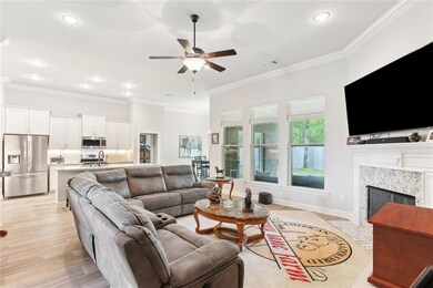 Open floor plan with wood plank tile in living are