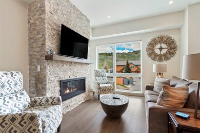 Living area featuring recessed lighting, a stone f
