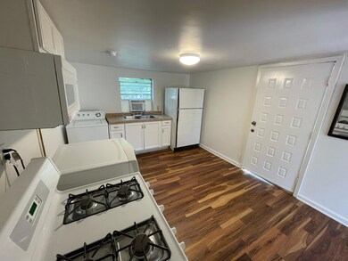 Kitchen with white cabinets, white appliances, da