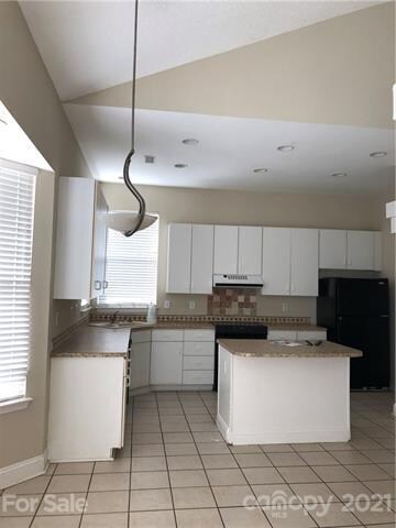 Kitchen with island and bay window