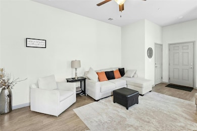 Living room featuring wood finished floors and ceiling fan