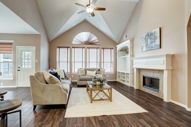 This living room boats a high cathedral ceiling, abundant natural light, and a warm homey feel from the floors and fireplace.  The built in cabinets to the left of the fireplace are large and setup for a TV if you wish.