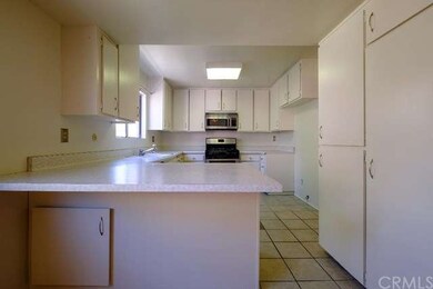 The kitchen features ample counter space, an eat-i
