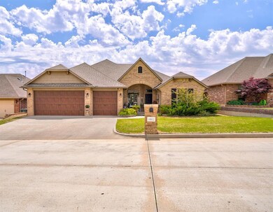 View of front of house with a garage and a front lawn