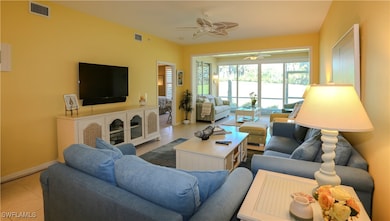 Tiled living area with visible vents, baseboards,