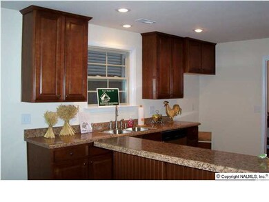 Kitchen Showing Raised Bar, Recessed Lighting, and Stainless Steel Appliances. Range is smooth top.