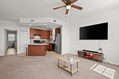 Living area with light carpet, recessed lighting, ceiling fan, and light tile patterned floors