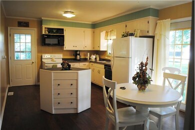 Beautifully updated kitchen with newer appliances, large plank laminate flooring and island.