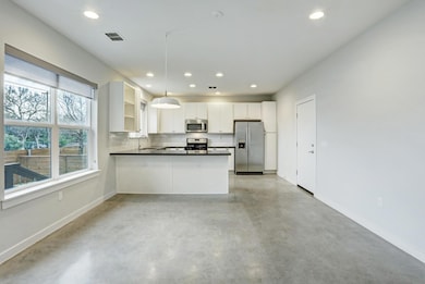 Kitchen featuring appliances with stainless steel