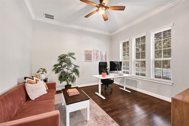 Bright home office with glass french doors and large windows.