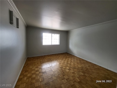 Unfurnished room featuring baseboards and crown mo