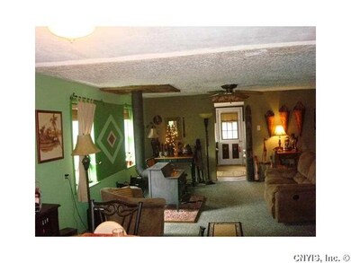 Living Room. View from DR. Doorway leads to enclos