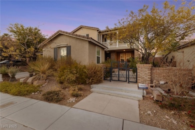 View of front of property featuring a balcony, a g