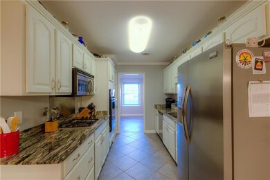 Kitchen with white cabinets, stainless appliances