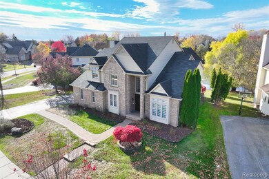 View of front facade featuring a front lawn and stone siding
