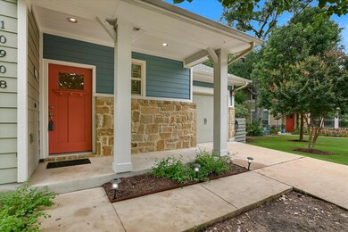 Entrance to property with stone siding and covere