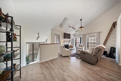 Inviting living space with vaulted ceilings, crown