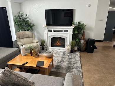 Tiled living area with a high end fireplace and baseboards
