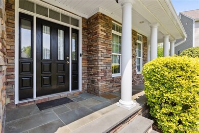 Property entrance featuring covered porch and bric