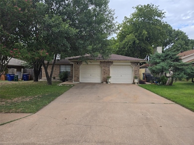 Ranch-style home with a front yard, concrete driv