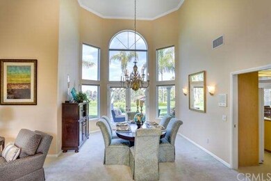 Dining room with chandelier and large windows enha