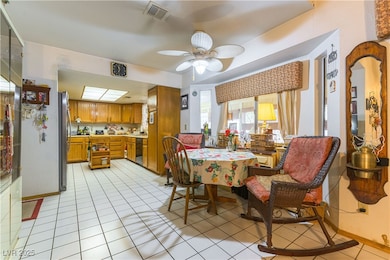 Dining room featuring a ceiling fan and light tile