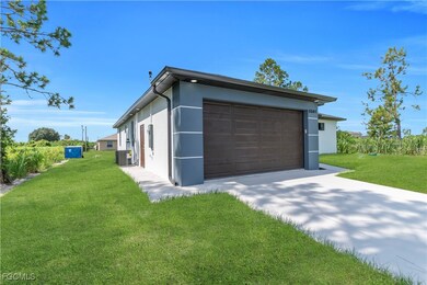 View of home's exterior with driveway, stucco siding, a yard, and an attached garage