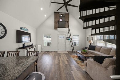 Living area with high vaulted ceiling, ceiling fan