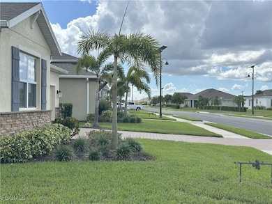 View of green lawn with a residential view