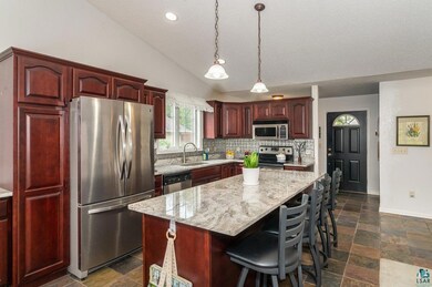 Kitchen with vaulted ceiling, dark tile patterned 
