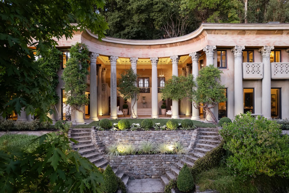 Sixteen Corinthian columns and a pair of spiral staircases front this home for sale in Berkeley, California. (Open Homes Photography)