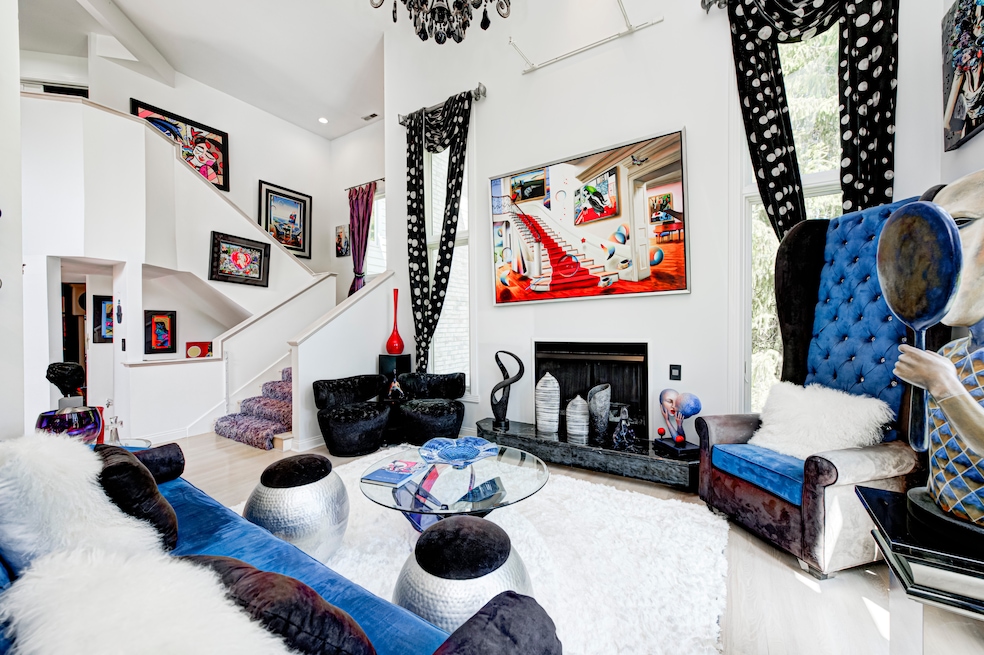 Cindy Sartino's home design was based in large part on an original surrealist painting by Brazilian artist Ferjo, which hangs above one of the home's three fireplaces. (BluPrint Real Estate Group)
