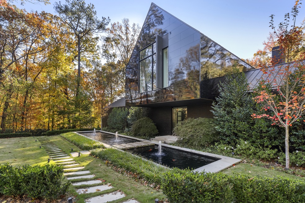 The exterior is covered with Meridian brick and black reflective wall panels. (Coldwell Banker)
