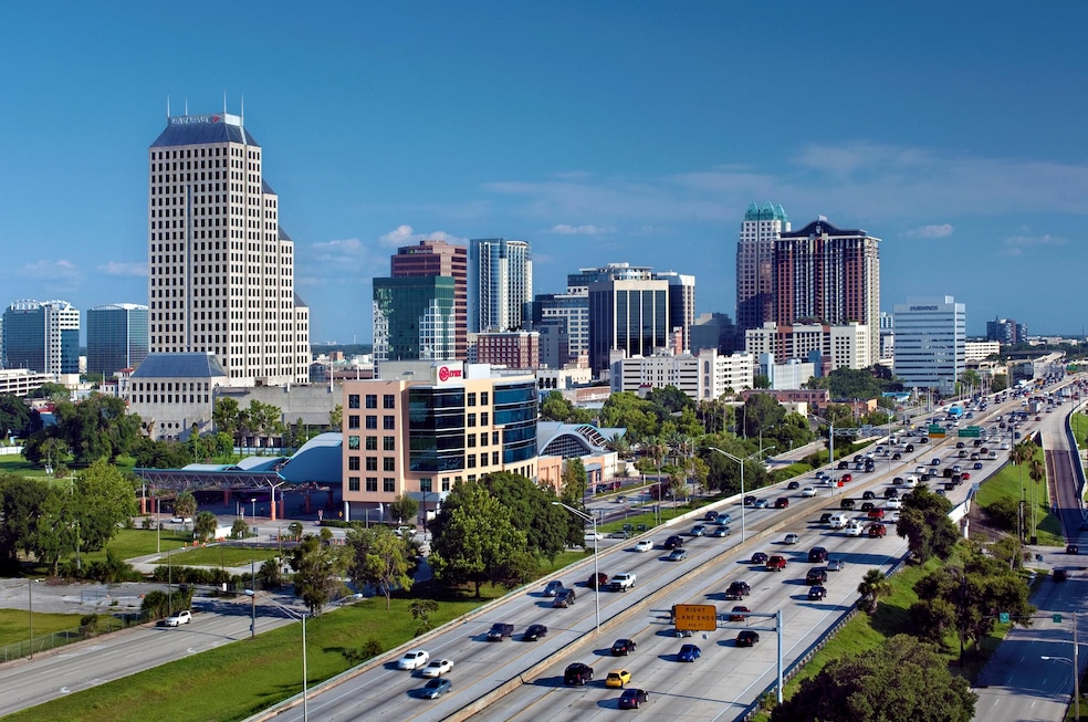 The skyline of downtown Orlando rises above the traffic on Interstate 4, a highway that runs east to west through central Florida. (Getty Images)