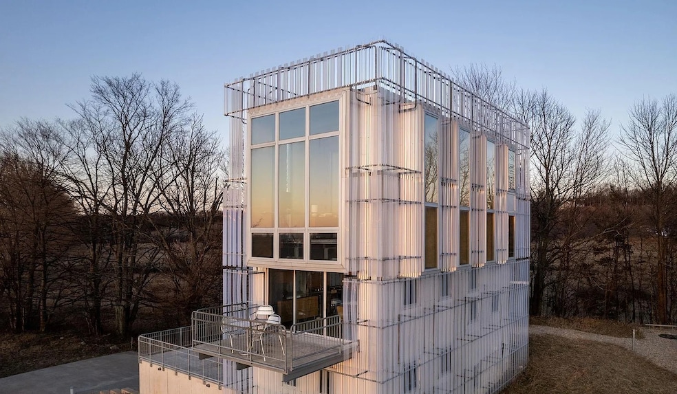 The house gets its name from its unique exterior that uses metal and plastic to subtly reflect sunlight. (Real Estate One)