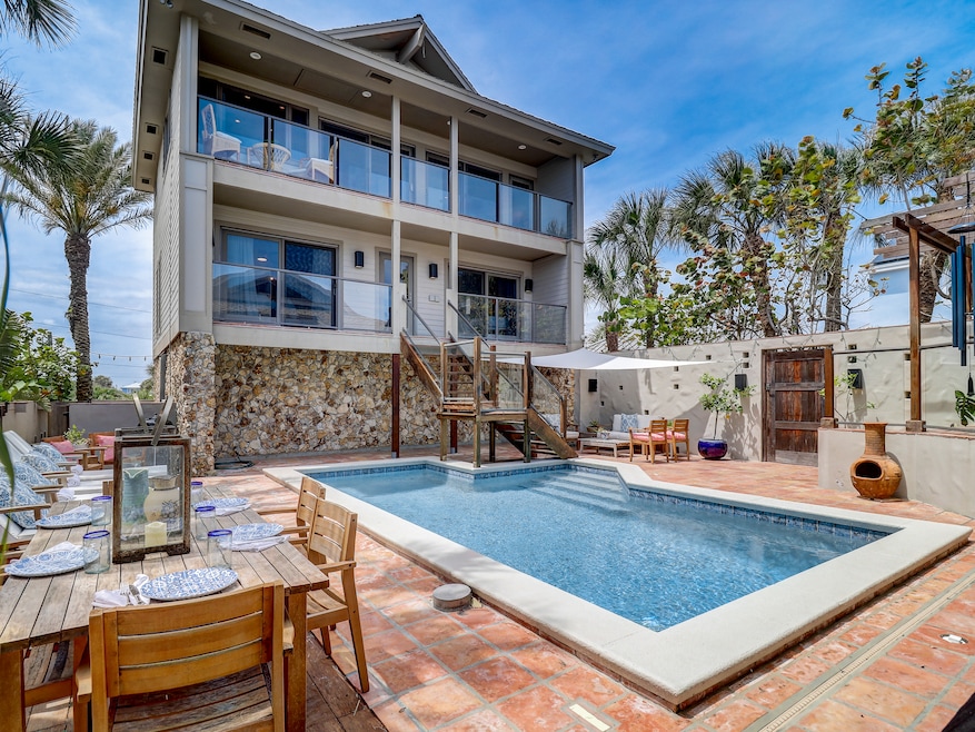 The home at 1421 N Atlantic Ave. in New Smyrna Beach, Florida, includes a walled courtyard with a pool. (Collado Real Estate)