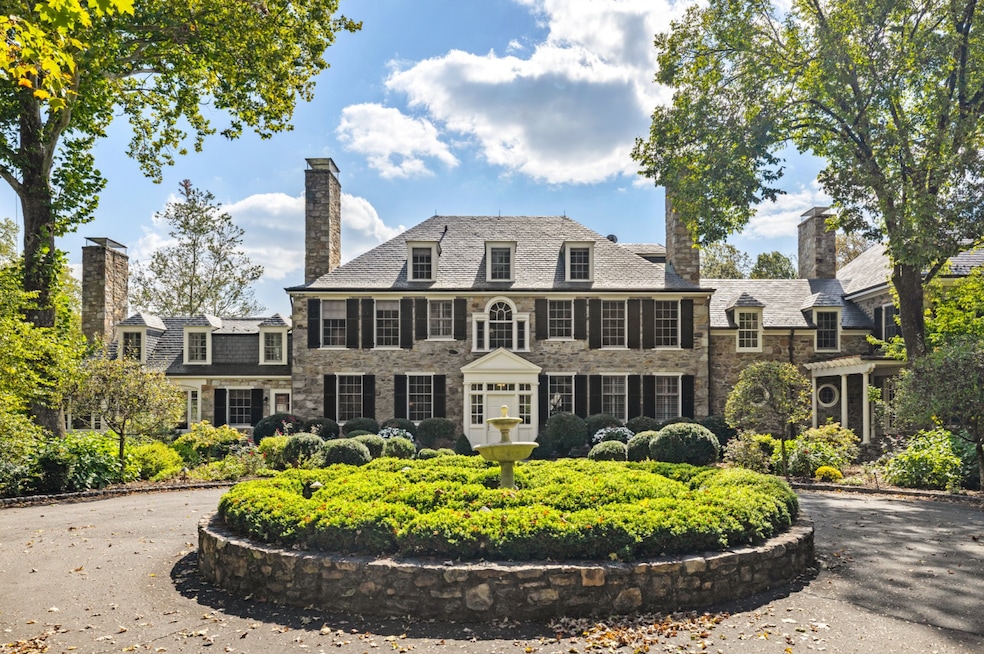 The property includes a nearly 100-year-old stone manor, a pool and horse stables. (Upward Studios)