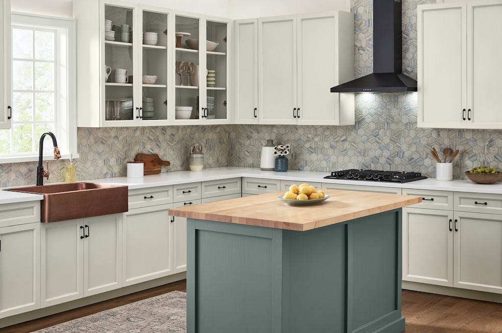 Kitchen cabinets painted in Valspar's Heritage Gray and a kitchen island in Coastal Dusk. (Valspar)