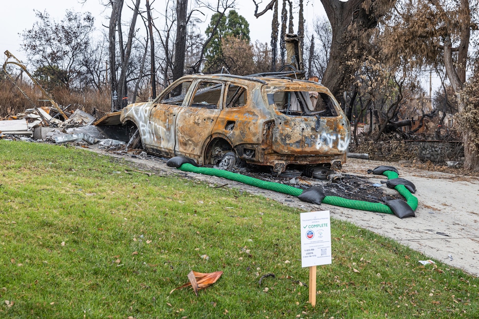 A sign posted in an Altadena, California, yard shows updates on the cleanup process in Los Angeles. (Kalina Mondzholovska/CoStar)