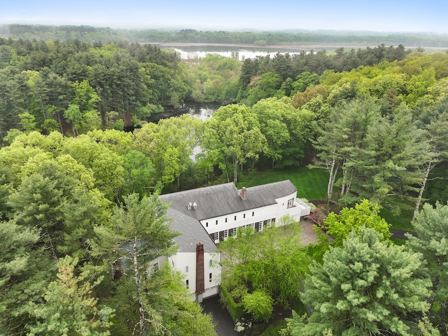 The home's backyard leads to a secluded pond, with the Concord River and a wildlife refuge just beyond. (Jack Vatcher Photography)
