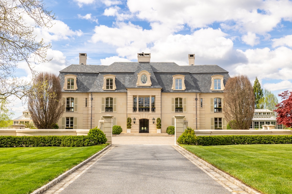 The main house is adjacent to a three-story guest house with 11 garage bays. (Derek &amp; Vee Team)