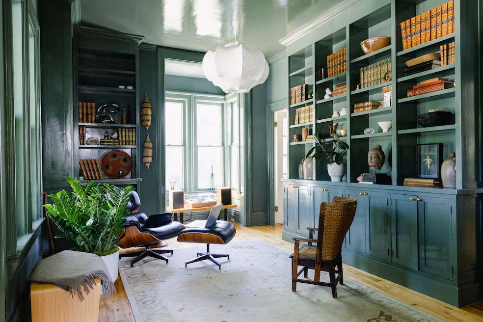 The seller painted the library with Farrow &amp; Ball's "Green Smoke" color, using a glossy finish on the ceiling. (Northern Migration)