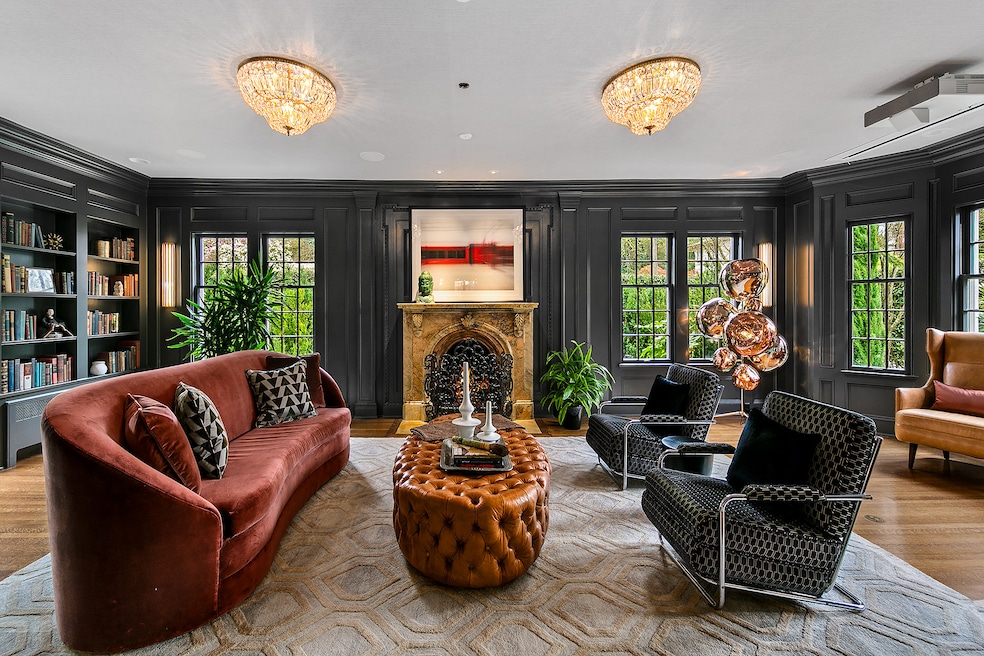 A sitting area near the main entrance provides a reading space and opens out to the backyard. (Gregory White/Seattle Home Photography)