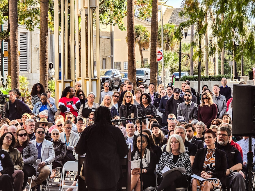 Karen Jackson of homeless service organization Zebra Youth addresses the crowd at Orlando's memorial service for unhoused people who died in 2025. (Trevor Fraser/Homes.com)