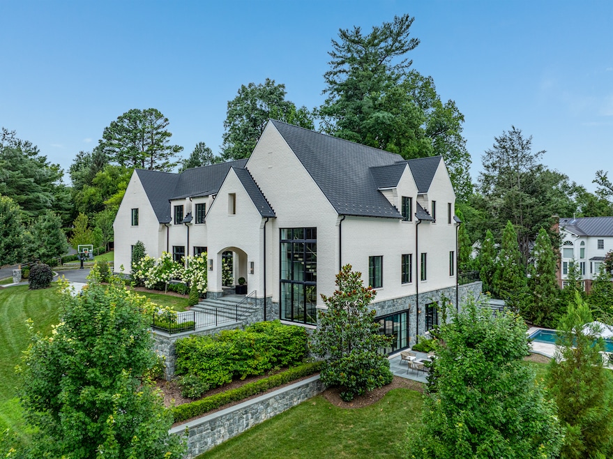The house's exterior is broken up into several distinct green and hardscaped areas. (The Yerks Team)